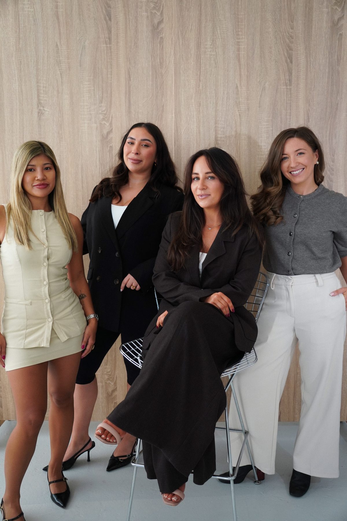 Melissa seated with Georgia, Nadiye and Michelle standing around her
